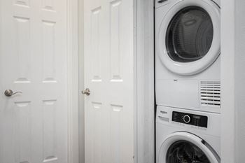 Ridge of Bellevue apartment with a white washer and dryer in a white laundry room